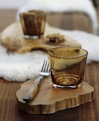 Wooden table set with white sheepskin mat and rustic slices of tree trunk