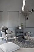 Stylish living room in shades of grey with antique armchair, fur rug and metal chandelier with bird ornaments