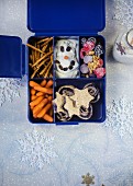Various winter snacks in a plastic box with compartments