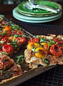 Puff pastry tart with red and yellow cherry tomatoes and basil (sliced)