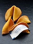 Two fortune cookies, one broken with fortune showing