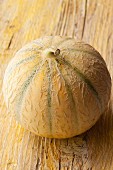 A melon on a wooden surface