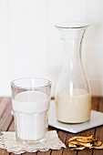Vegan milk in a glass and a carafe