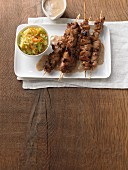 Satay skewers with a cashew and peanut sauce and a sweet and spicy coleslaw