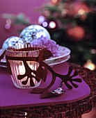 Glass tealight holder with felt decoration on table