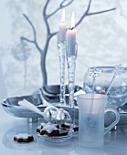 Festive, white and silver table arrangement with dish and glass candlesticks
