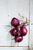 Red onions on a white wooden table