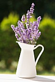 A jug of lavender on a garden table