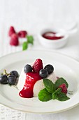 Panna cotta with fresh raspberry sauce and red grapes