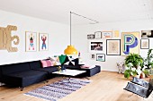 Charcoal sofa combination and gallery of pictures in spacious living area with Scandinavian retro ambiance