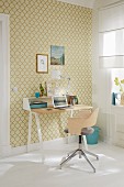 A desk against a wall with golden and yellow-green ornamental patterned wallpaper