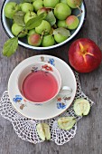 A cup of fruit tea and fresh fruit