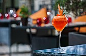 A cocktail garnish with melon carrots on a patio table (Buddha-Bar Hotel, Paris)