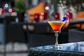 An exotic fruit cocktail on a patio table (Buddha-Bar Hotel, Paris)