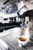 An espresso cup on an espresso machine