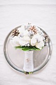 A bride's bouquet on a silver plate