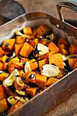 Baked pumpkin and onions, garnished with toasted pumpkin seeds and herbs