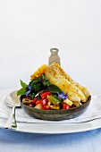 Baked fish fillet served with vegetables in a small pan