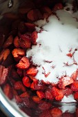 Strawberries and sugar in a pot for making strawberry jam