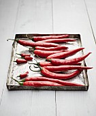 Fresh red chilli peppers on an old baking tray