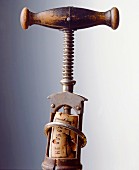 An antique corkscrew with a cork