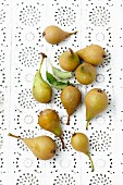 Fresh green pears on a lace surface