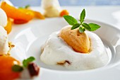 Apricot and elderberry dessert garnished with mint leaves