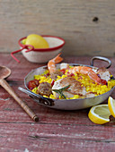 Oven-baked risotto with fish, chicken and garlic sausage