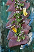Tuna fish salad with red onions, rocket and pansies