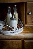 Vegan hazelnut milk, almond milk and coconut milk on a vintage tray