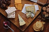 An English cheese platter with chutney, crackers and walnuts