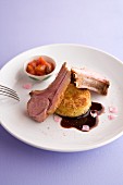 Saddle of milk-fed lamb with a potato cake and tomato and rose coulis