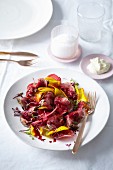 Herb beef with a beetroot carpaccio and beetroot reduction
