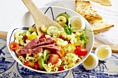Amsterdam pasta salad with cherry tomatoes, hard-boiled eggs and corned beef