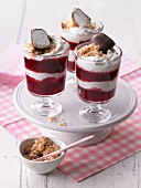 Layered deserts with red berry jelly and chocolate cream