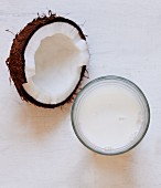 Half a coconut and a glass of coconut milk