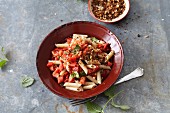 Vegetarian penne pasta with goji berries, tomatoes and mint