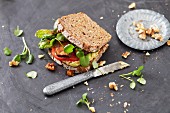 A vegan sandwich with tofu, tomatoes and watercress