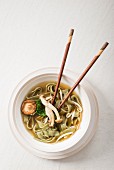 Japanese noodle soup with mushrooms and fresh spinach noodles