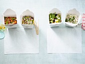 Four filling low carb salads in takeaway boxes
