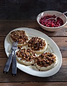 Gratinated celeriac slices with a nut crust served with a lingonberry sauce
