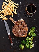 Prime rib steak with fries and broccoli