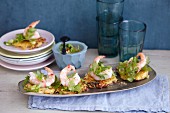 Mini potato fritters with prawns, coriander and limes