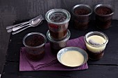 Chocolate cake in jars with cherry compote and white chocolate