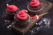 Christmas lingonberry and gingerbread cupcakes decorated with Father Christmas hats