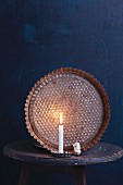 An old baking tin in candlelight as a Christmas decoration