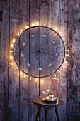 An old bicycle wheel upcycled with fairy lights to make a Christmas decoration