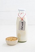 Oat milk in a glass bottle with a label