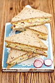 Sandwiches with egg salad and radishes