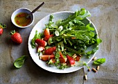 Rocket salad with strawberries and pine nuts